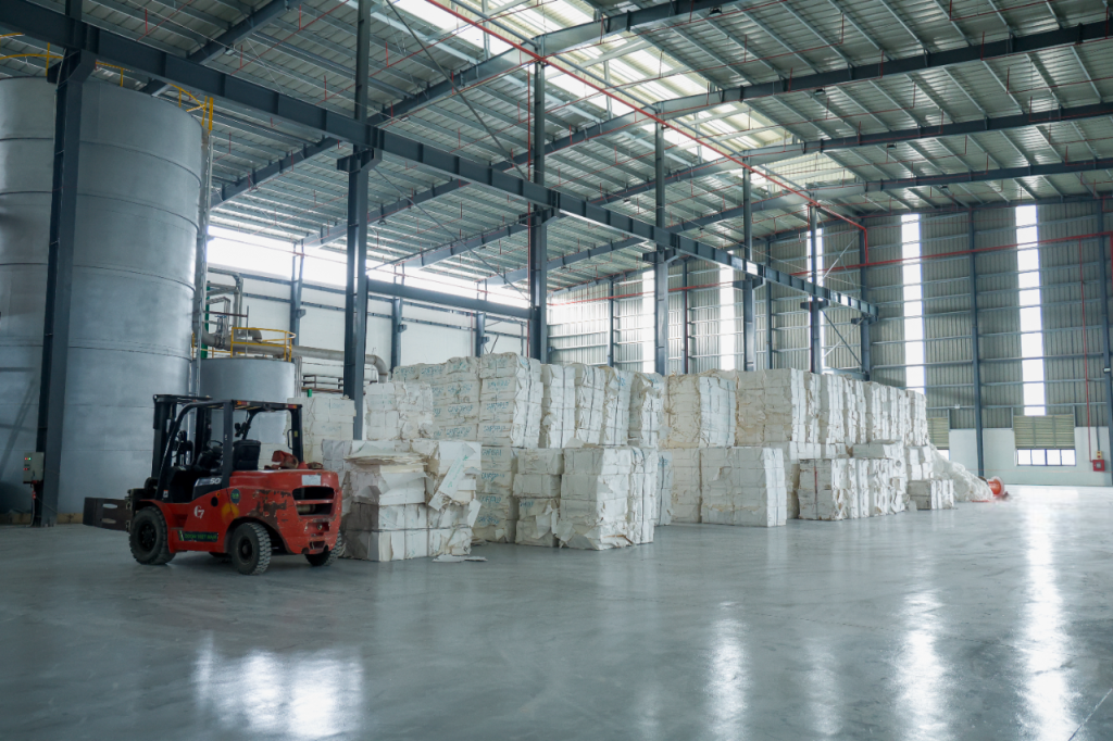 Paper warehouse with jumbo tissue rolls and raw materials